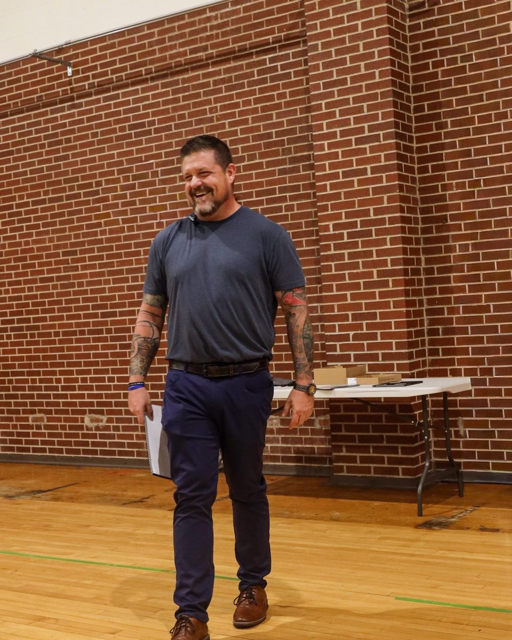 Steve Baumgartner laughing as he walks toward a workshop group